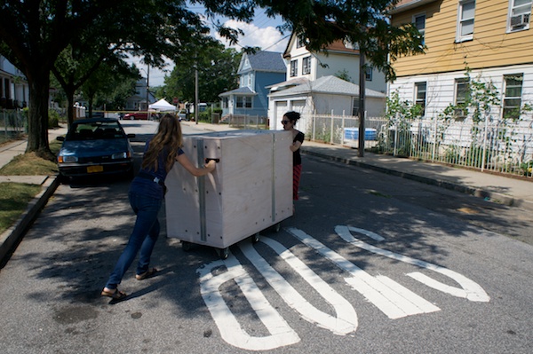 Emily Jacobson and Leslie roll the Uni cart into position.