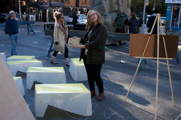 Uni Volunteer Kelly Blanchet completes Tangram puzzle, putting the learning in "books and learning."