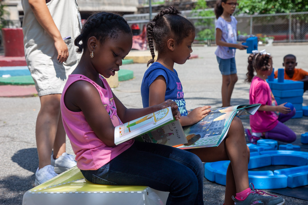 These girls are having fun in the reading room