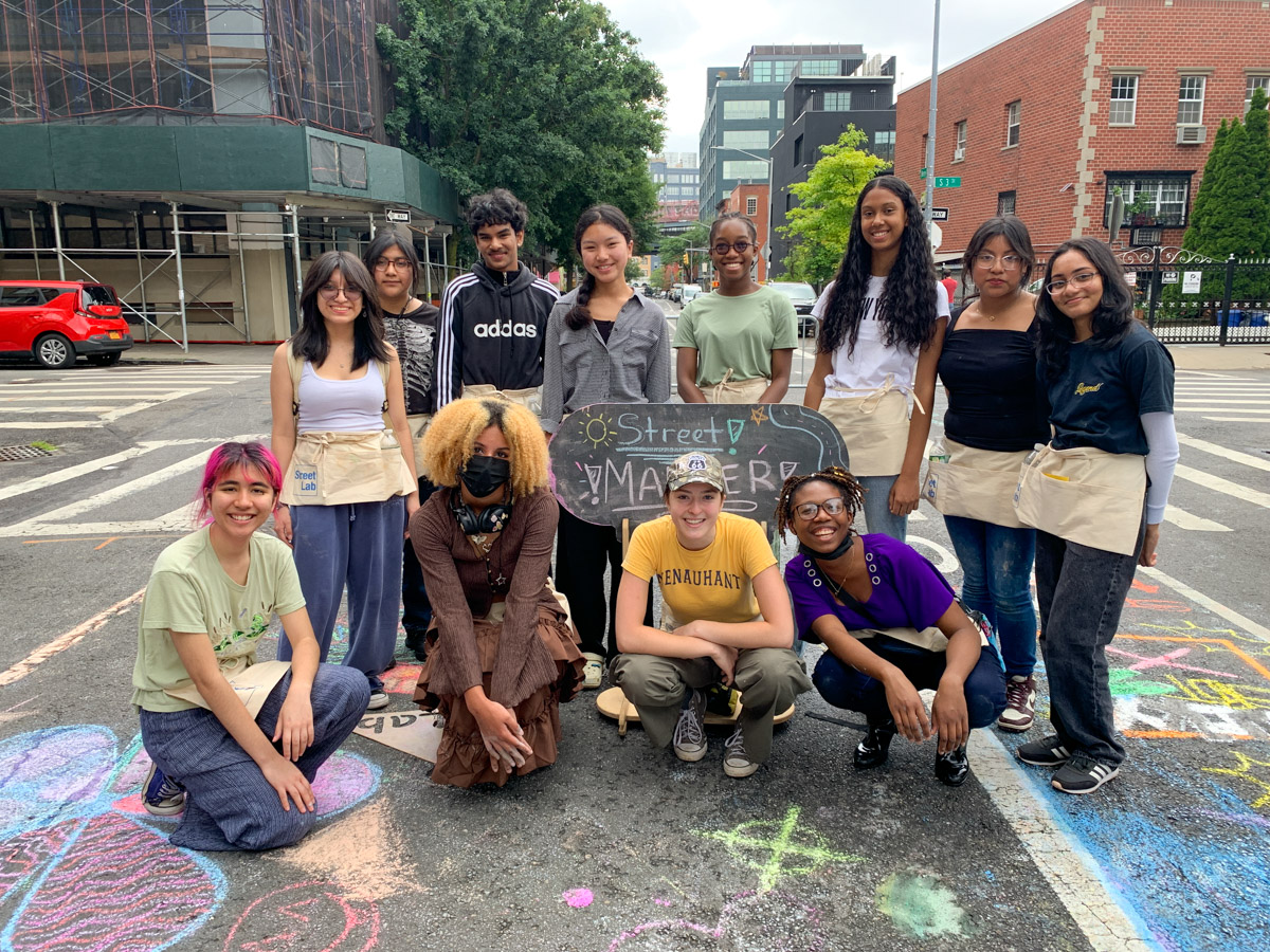 A group photo of teenagers on a street in New York City.