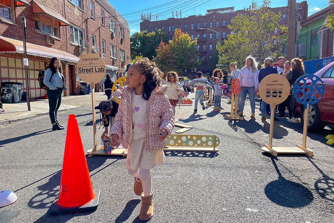 A little girl standing on an Open Street in NYC.