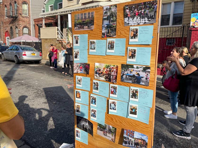 a wooden board with photos and notes (written by elementary students) on what they want to see on their street