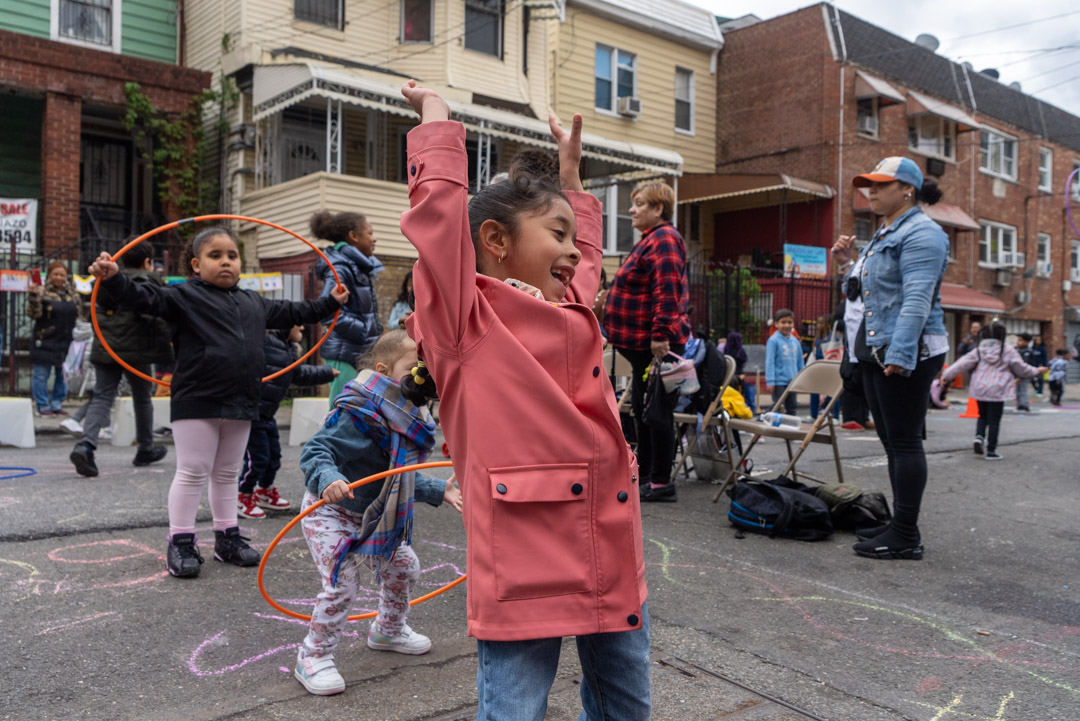 a teacher leading a group of elementary school students a workshop on reimagining our streets