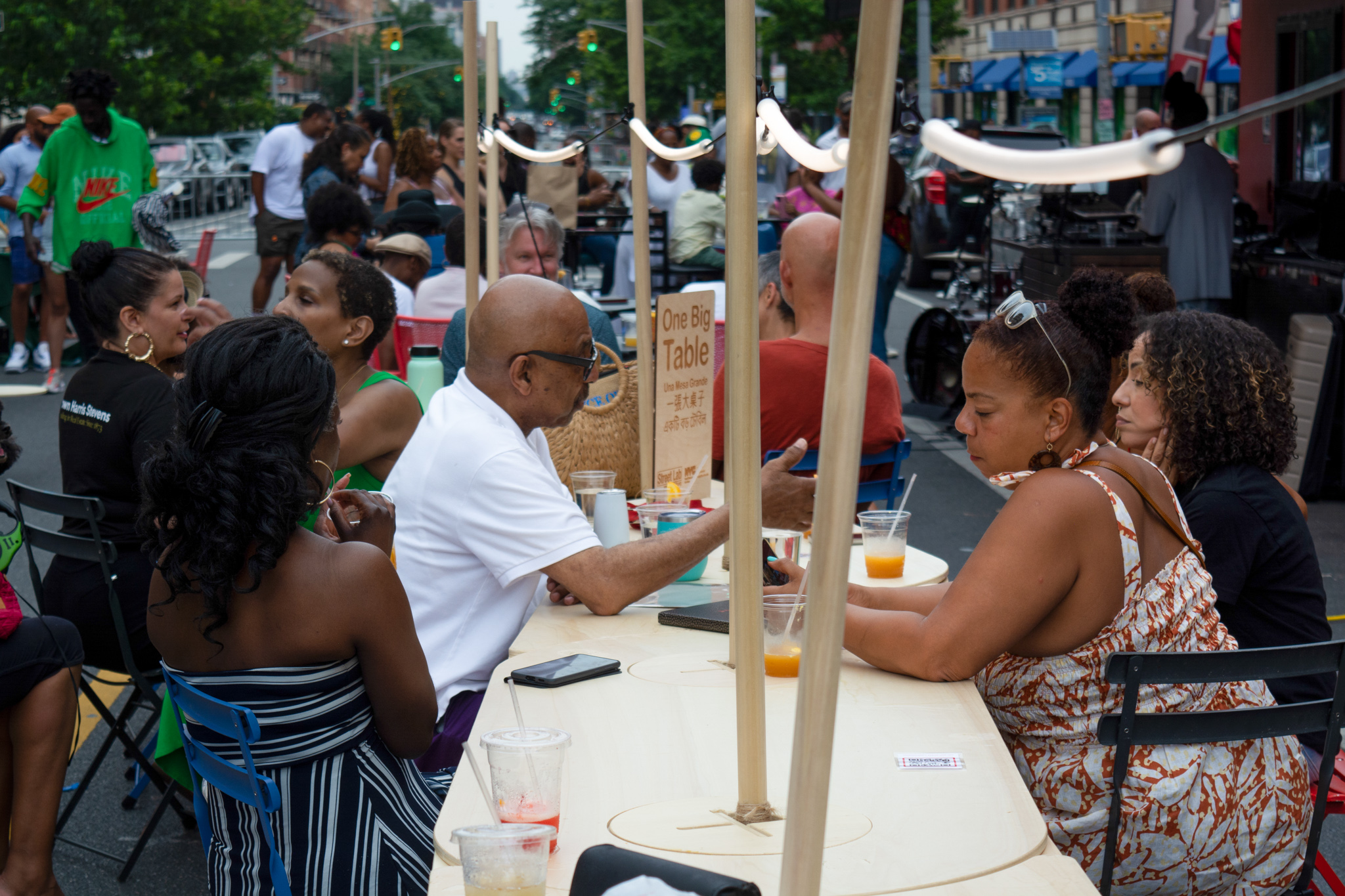 People sitting together at an One Big Table on the street.