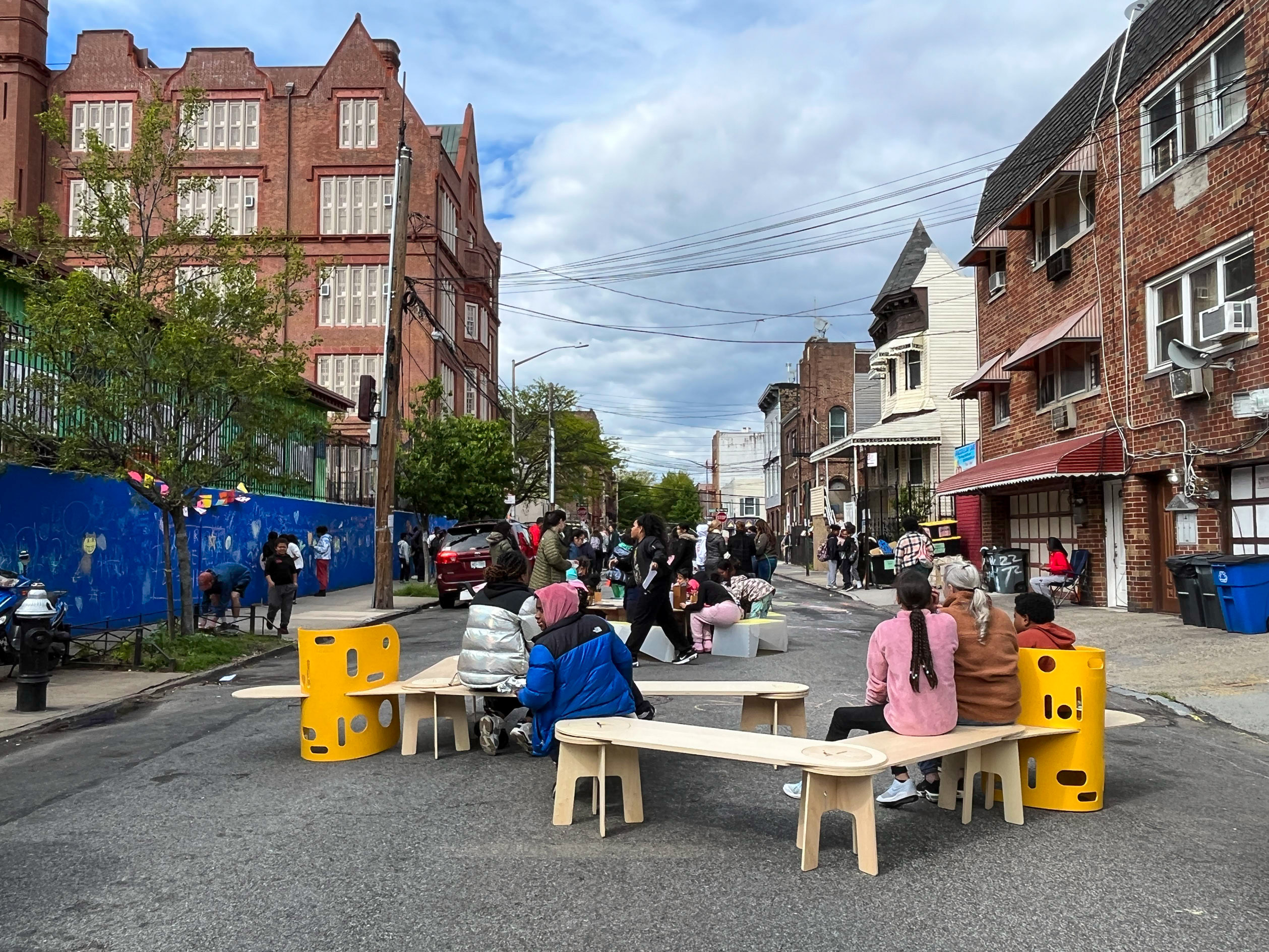 a teacher leading a group of elementary school students a workshop on reimagining our streets