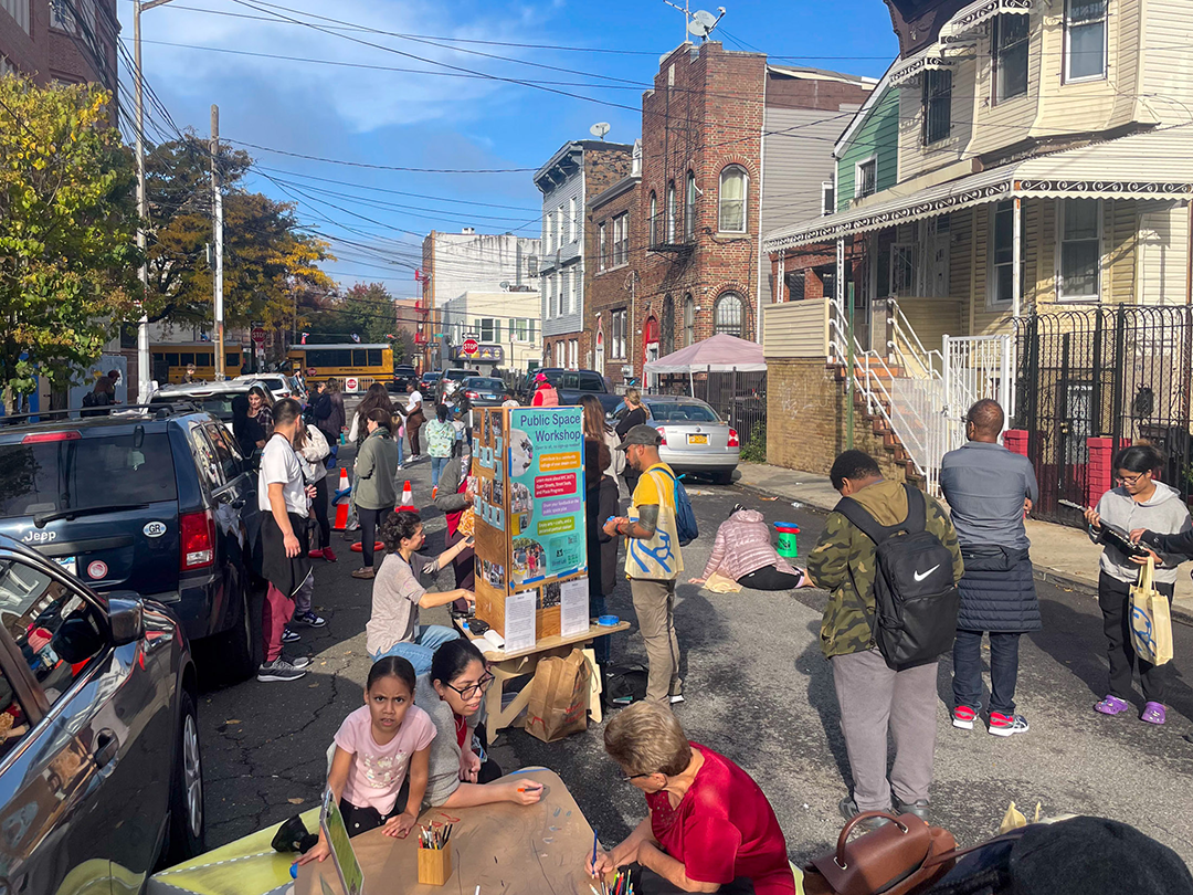 a car-free open street with children and adults engaging in different activities