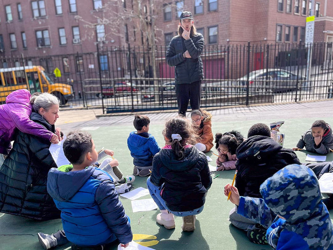 a teacher leading a group of elementary school students a lesson in a playground