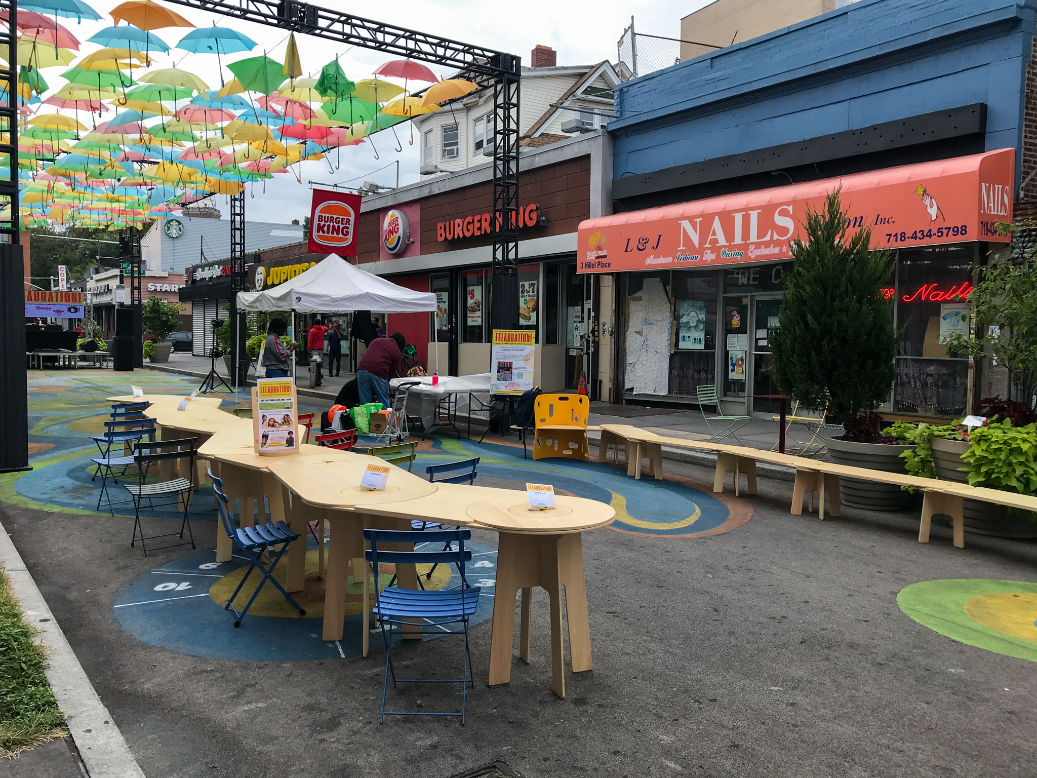 A photo of a wooden table at a plaza.