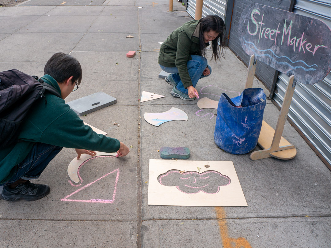People chalking on the street.
