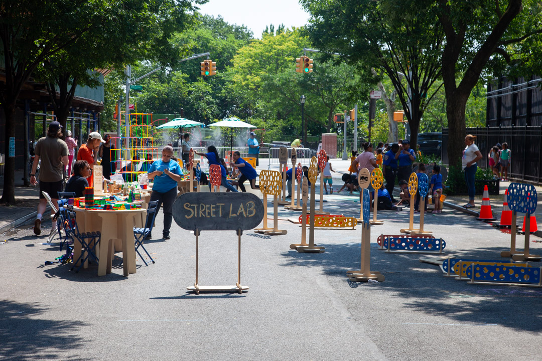 A view of different cultural programs on an open street in NYC.