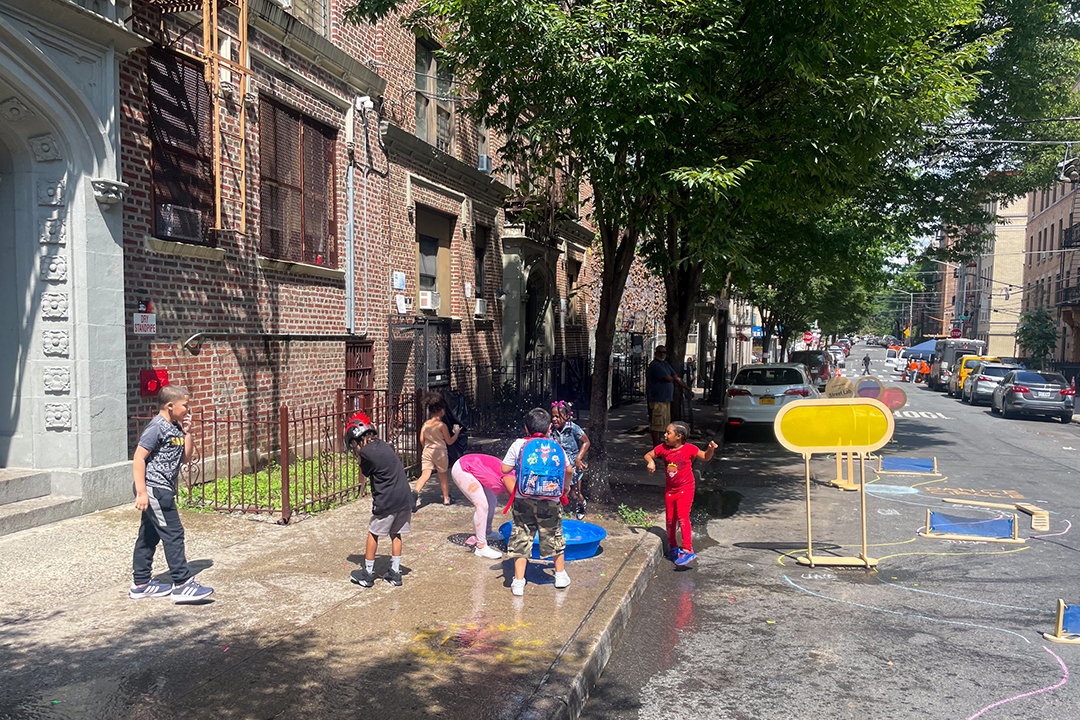 A group of children playing on an Open Street in NYC.