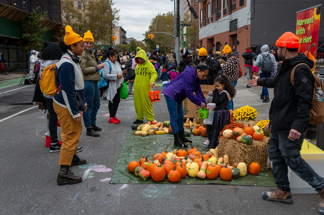 People drawing on an One Big Table by Street Lab at an open street in NYC.