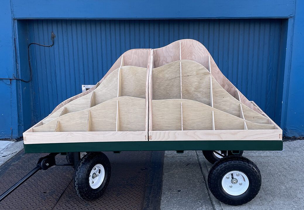 A wooden fixture placed on a cart with wheels.