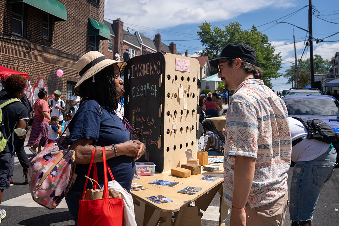 A woman and man talking on the street.
