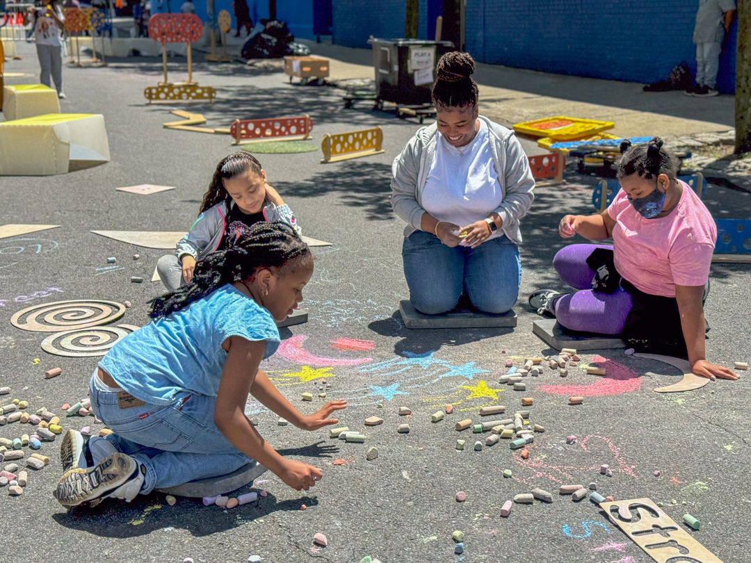 Students chalking on the ground.