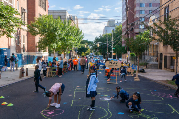 A view of a vibrant open street next to a school.